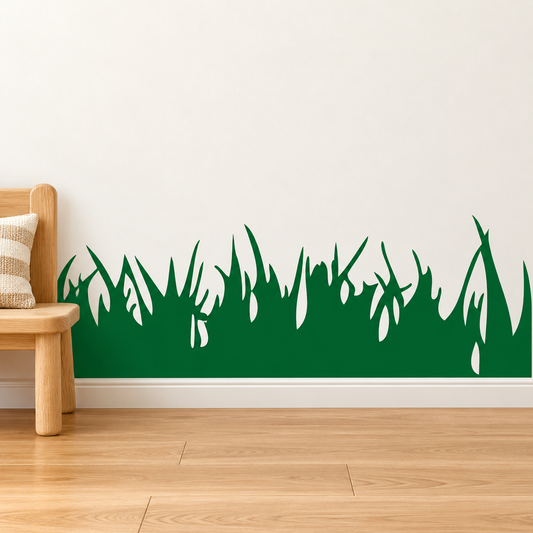 Green grass border wall decal above a baseboard beside an oak chair