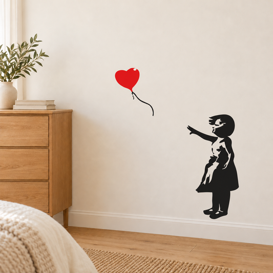 Girl and red heart balloon wall decal shown beside an oak dresser