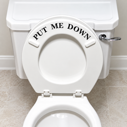 Black Put Me Down lettering on a raised white toilet seat