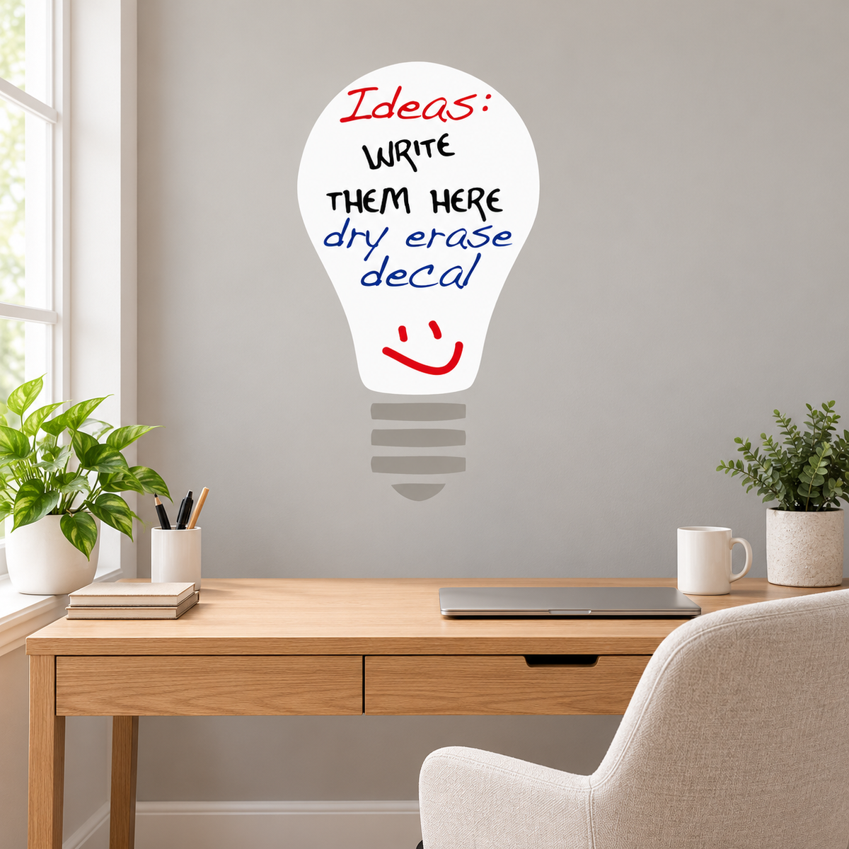 White dry erase light bulb wall decal with gray base above a home office desk