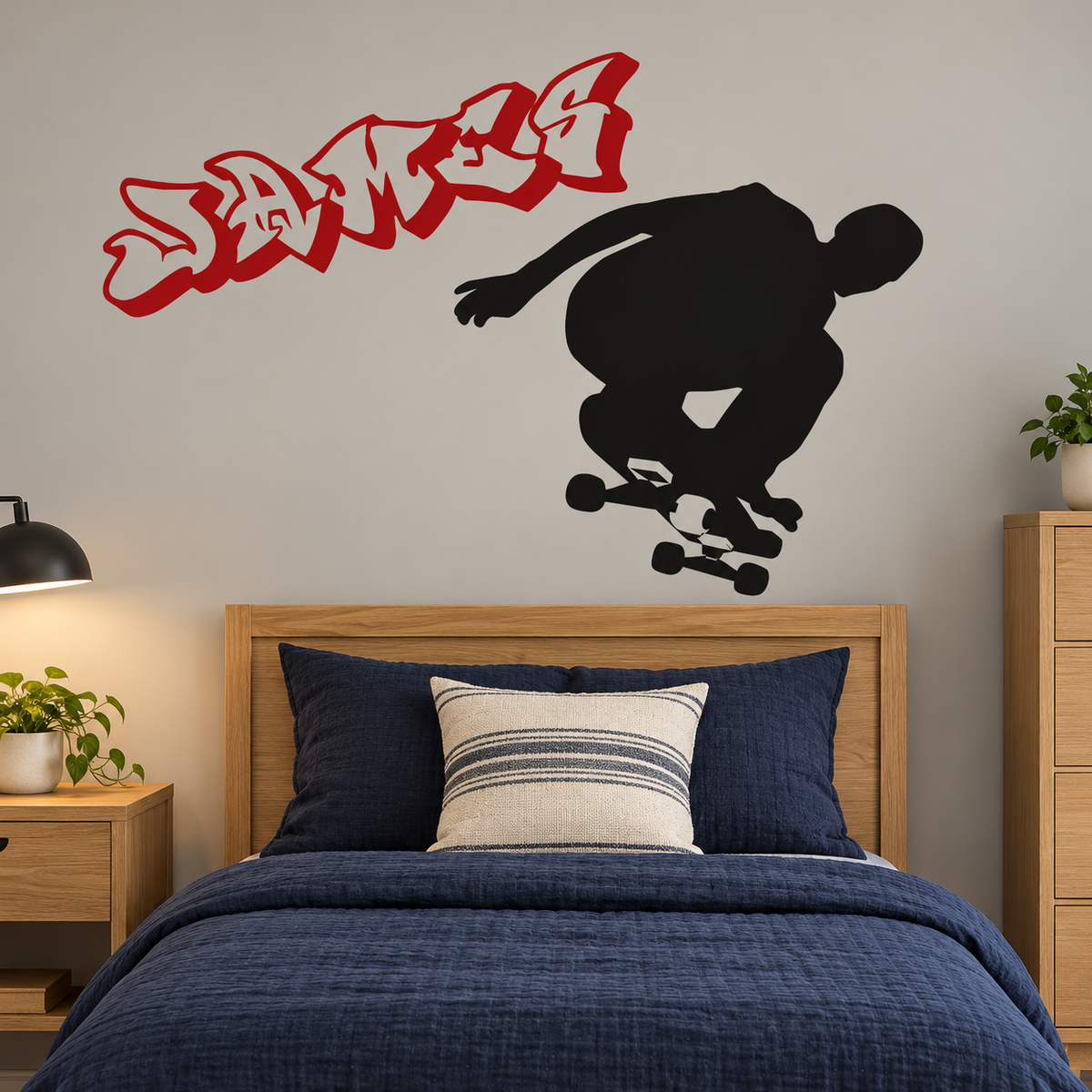 Black skateboarder wall decal above an oak twin bed with navy bedding; red name lettering shown separately