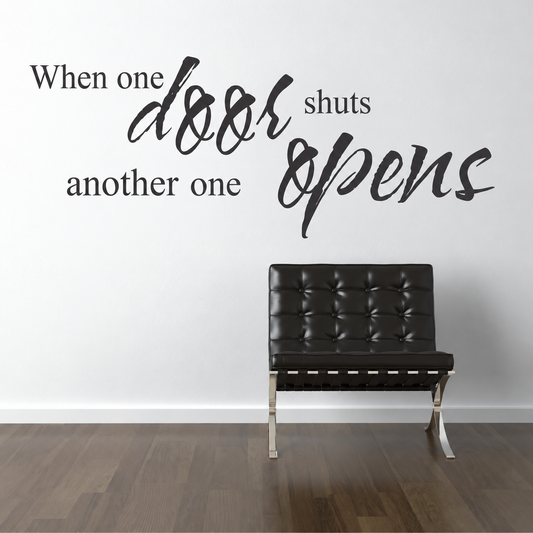 when one door shuts another opens wall quote decal displayed on a wall
